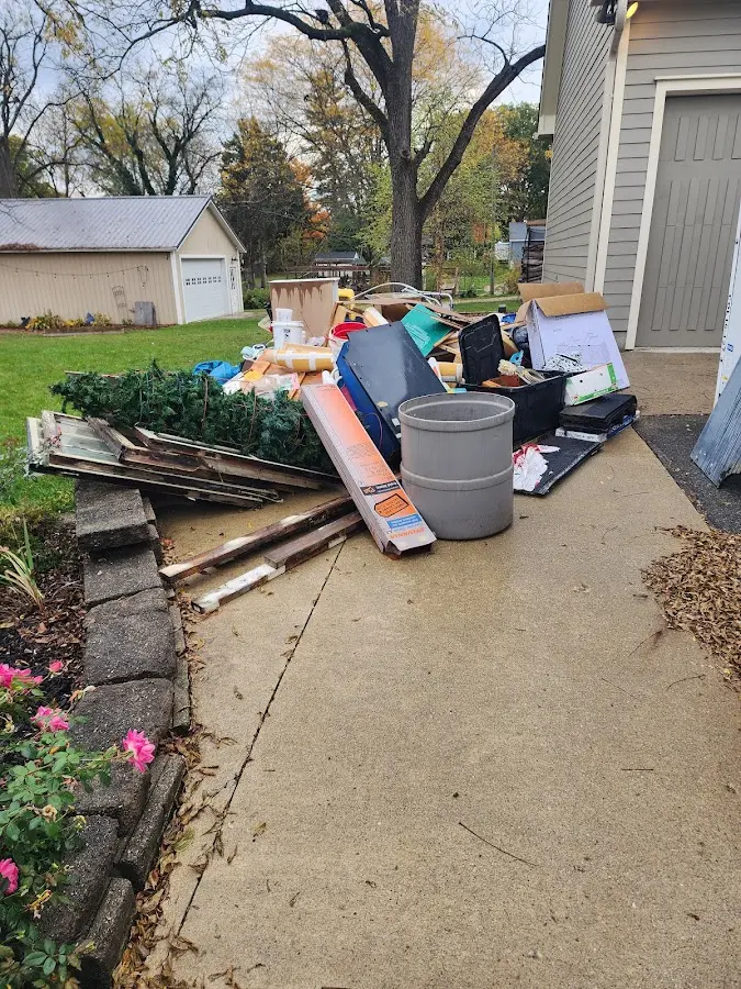 Dumpster being loaded with debris for 3 Yard Dumpster Rental in Neptune Beach